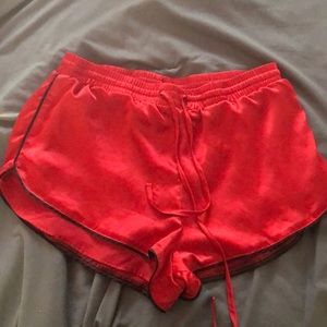 Large red silk shorts with black trimmings